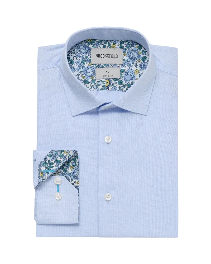 Light blue dress shirt with floral patterned collar and cuff on a white background