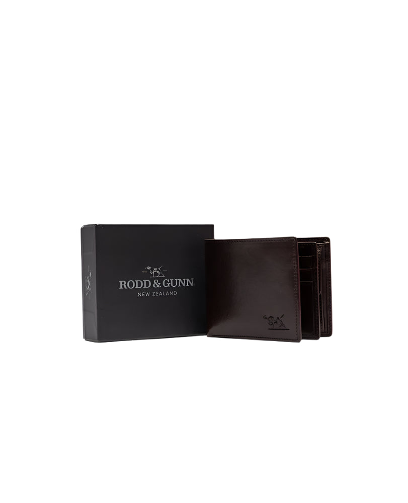 Brown leather wallet with open box displaying 'Rodd & Gunn New Zealand' on a light gray background